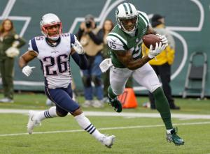 New York Jets wide receiver Brandon Marshall (15) catches a pass for a touchdown in front of New England Patriots' Logan Ryan (26) during the second half of an NFL football game, Sunday, Dec. 27, 2015, in East Rutherford, N.J. (AP Photo/Seth Wenig)